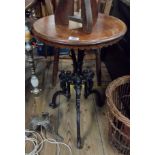 A 45cm diameter late Victorian mahogany topped table with petal apron, set on an ornate cast iron