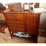 An 80cm early 20th Century walnut music cabinet with five Stones Patent drop-front drawers and