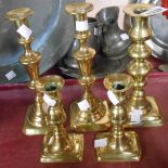 A pair of 19th Century brass candlesticks - sold with a smaller pair and a single similar