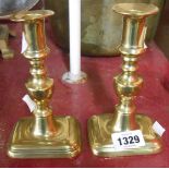 A pair of 19th Century cast brass candlesticks