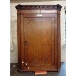 An 80cm late Georgian inlaid oak and mahogany wall hanging corner cabinet with dentil cornice and