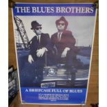Three rolled posters: comprising Blues Brothers 'A Briefcase Full of Blues', Pink Floyd Wembley
