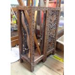 An Indian carved hard wood stick stand with pierced grapevine panels and replacement base -