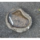 A concrete bird bath top