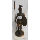 A cast metal figure depicting a Trojan soldier with bronze effect finish set on marble base