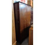 A 97cm Stag Minstrel wardrobe with hanging space, slides and shelves enclosed by a pair of moulded
