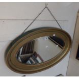 A vintage gilt and painted wood framed bevelled oval wall mirror