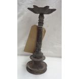 An antique Middle Eastern cast bronze oil wick lamp