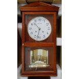 A boxed Rhythm Model. CMH 714 NR 02 stained wood cased wall clock with melody movement