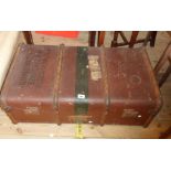 A 90cm vintage weather coated tin and cane bound travelling trunk with flanking leather strap