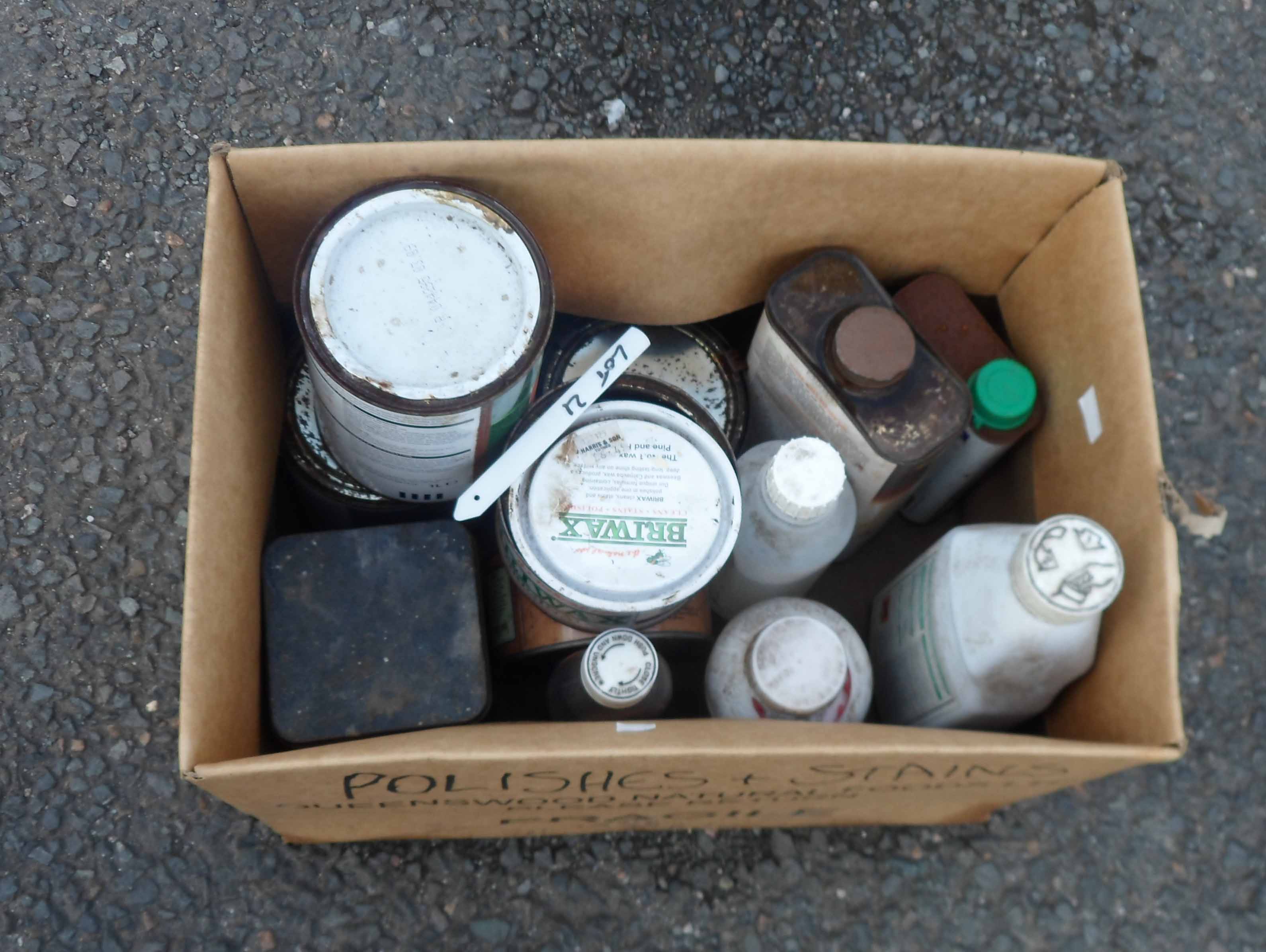 A box containing assorted joinery waxes and oils