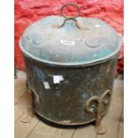 An Arts & Crafts period beaten copper coal box of cylindrical form with wrought iron feet and