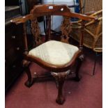 A far Eastern hardwood framed corner elbow chair in the Victorian style with pierced splat back