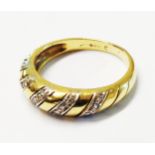 An import marked 750 (18ct.) gold ring, set with diagonal bands of tiny diamonds - size L