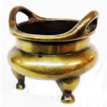 An antique Chinese bronze censer with flanking pierced handles and four character seal mark to base