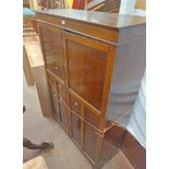 A 1.07m 1920's polished oak wardrobe with shelves, two drawers and hanging space enclosed by a