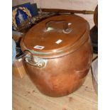 A large antique copper saucepan and lid of oval form with wrought iron handles