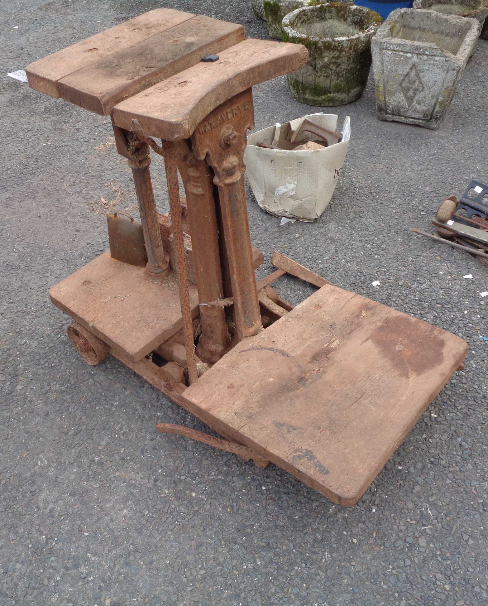 A set of antique cast iron potato scales with wooden fittings