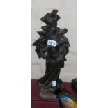 A late Victorian spelter figure of a woman with bronze effect finish set on red marble base