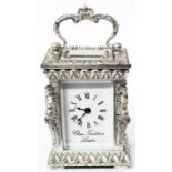A boxed 8cm high Charles Frodsham & Co. Ltd ornate silver and bevel gass cased carriage timepiece