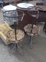 A pair of wrought iron two tier freestanding garden flower baskets