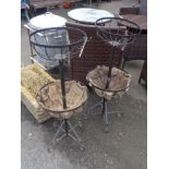 A pair of wrought iron two tier freestanding garden flower baskets
