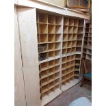 A modern mixed wood freestanding shop pigeon-hole storage/display unit comprising four sections,