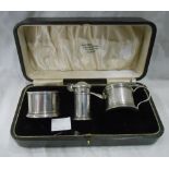 A cased silver three piece condiment set with original spoons and blue glass liners - Birmingham