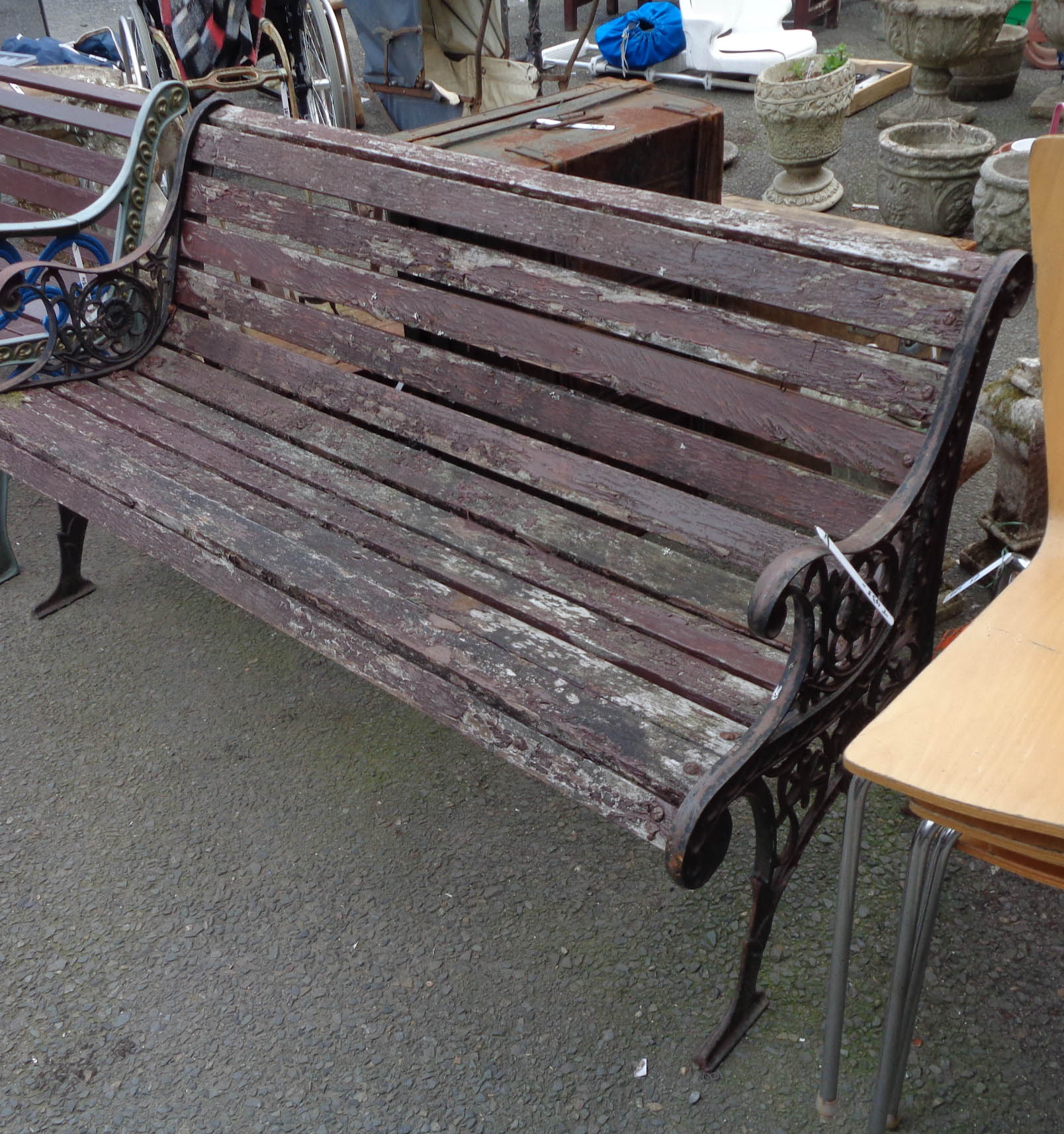 A garden bench with cast iron ends and slatted wooden seat