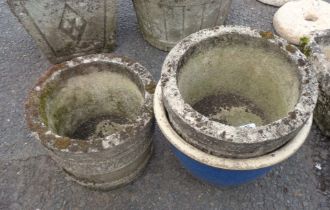 Two circular concrete planters and a glazed garden pot