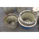 Two circular concrete planters and a glazed garden pot