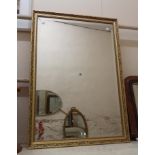 A modern gilt framed bevelled oblong wall mirror with decorative border