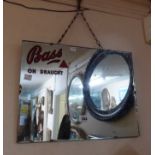 A vintage frameless small square advertising wall mirror with red text 'Bass ON DRAUGHT'