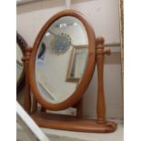 A modern pine framed swing dressing table mirror with bevelled oval plate - sold with a small pine