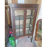 A 74cm Edwardian mahogany and strung display cabinet with material lined interior enclosed by a