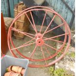 A pair of old cast iron cartwheels with later red painted finish