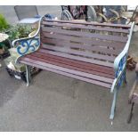 A garden bench with painted cast iron ends and wooden slatted seat