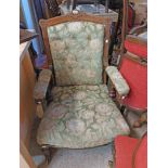 An Edwardian stained oak part show frame drawing room armchair with button back floral tapestry