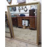 A 100cm modern gilt framed bevelled oblong wall mirror with decorative border