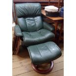 A Stressless reclining armchair with green leather upholstery, set on a circular stained bentwood