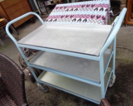 A vintage tubular industrial catering trolley with three set-in aluminium trays with later blue