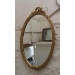 A modern gilt framed Georgian style oval wall mirror with decorative pierced pediment