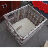 A rustic slatted wood log crate