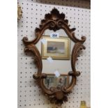 A small gilt framed Rococo style wall mirror