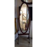 A modern mahogany framed cheval mirror with oval plate, set on standard ends with splayed legs - a/