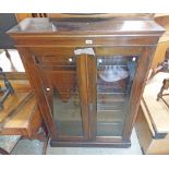 A 94cm 1930's stained mixed wood display cabinet with plate shelves and hooks enclosed by a pair