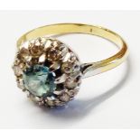 A re-shanked ring, set with central aquamarine within a diamond encrusted border - size M