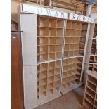 A modern mixed wood freestanding shop pigeon-hole storage/display unit comprising four sections,