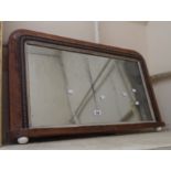 An 85cm Victorian figured walnut veneered overmantle mirror with decorative border and porcelain