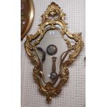 A reproduction giltwood framed Rococo style wall mirror with pierced border